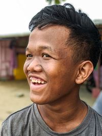 Close-up of smiling boy looking away outdoors