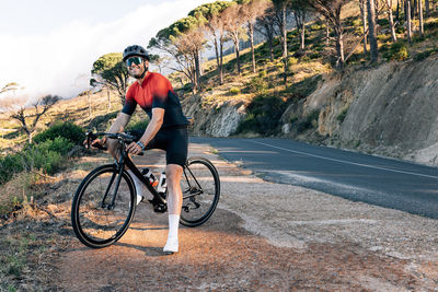 Man riding bicycle on road