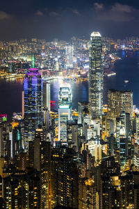 Illuminated cityscape against sky at night