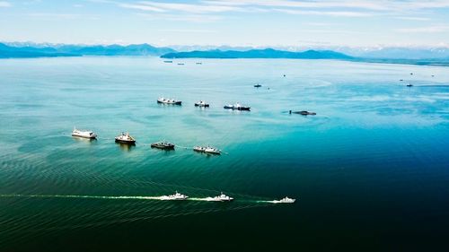 High angle view of sailboats in sea against sky