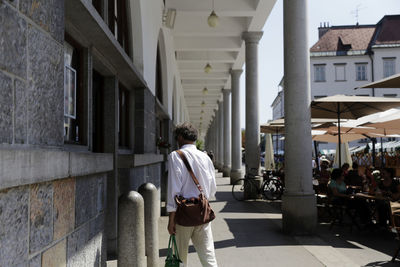 Rear view of people walking on building