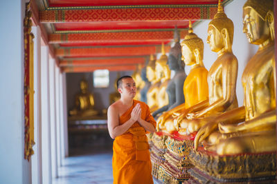 Statue of buddha against building