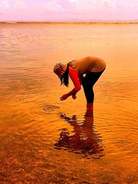 Full length of girl playing in water