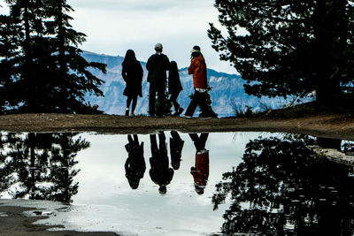 People walking by lake