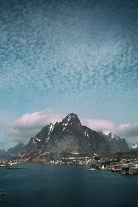 Houses by sea against mountains