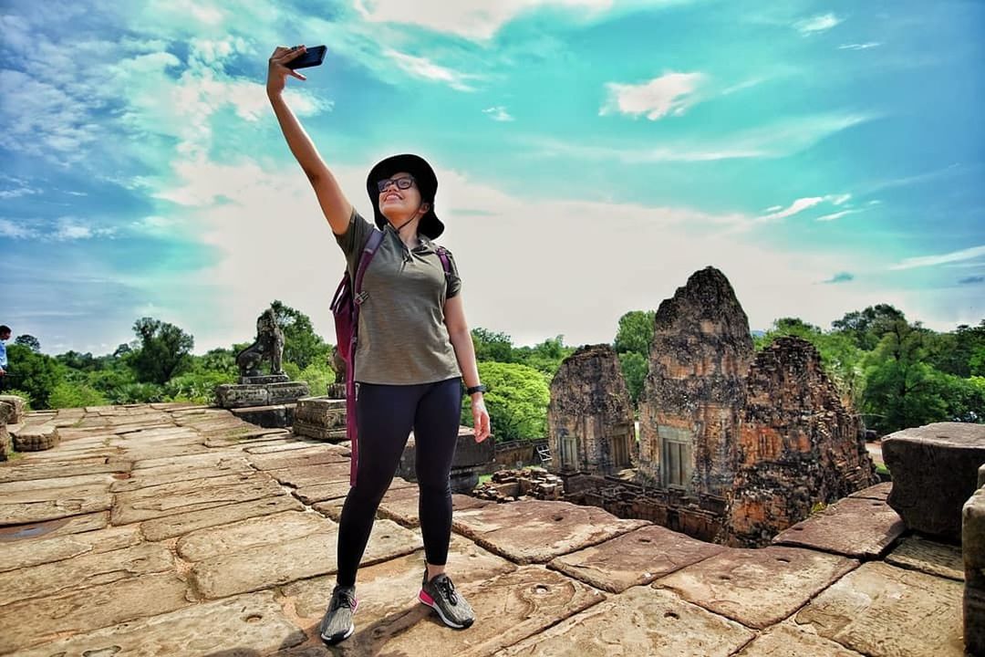 real people, sky, one person, lifestyles, cloud - sky, full length, leisure activity, young adult, standing, nature, casual clothing, front view, young women, beauty in nature, day, portrait, solid, adult, human arm, outdoors, arms raised