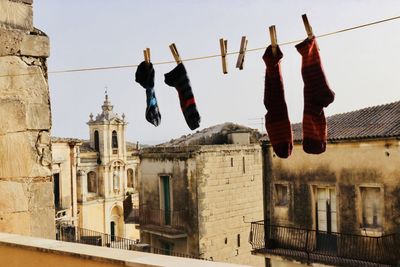 Low angle view of clothes drying against buildings