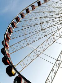 Low angle view of ferris wheel against clear sky