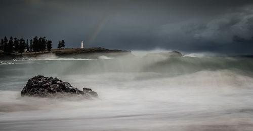 Scenic view of rainbow over sea against sky