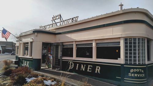 Low angle view of text on building against sky