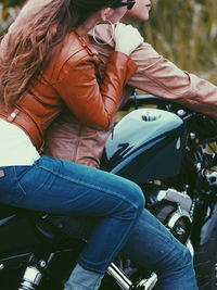 Rear view of woman riding motorcycle