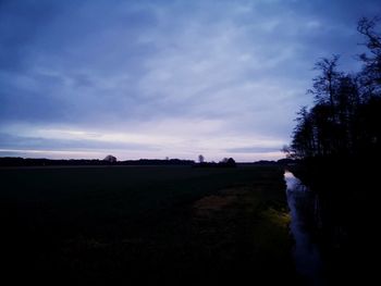 Scenic view of silhouette landscape against sky at sunset