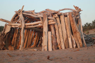 Stack of logs against clear sky