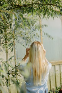 Woman standing by plants