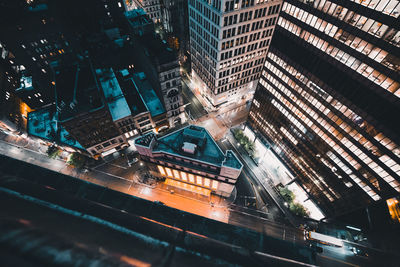 High angle view of illuminated city street and buildings