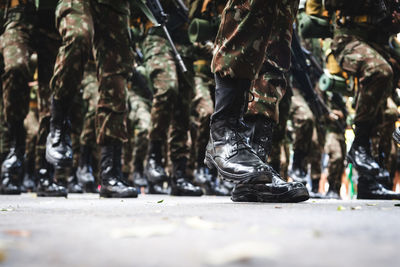  low view of the legs of brazilian army soldiers marching through the streets of salvador, bahia