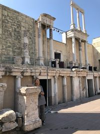 Rear view of man outside historic building