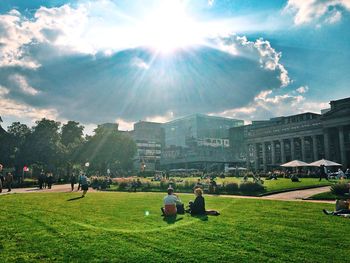 People relaxing on grassy landscape