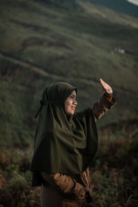 Young woman standing on field