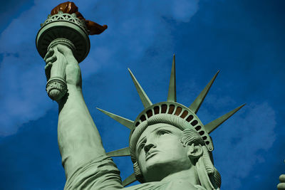 Low angle view of statue against blue sky