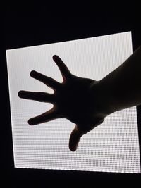 High angle view of silhouette person against black background
