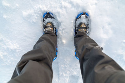 Directly above shot of man snowshoeing on snowcapped mountain