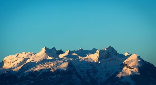 Scenic view of mountains against blue sky