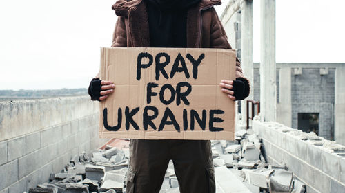 Ukrainian boy holding an anti-war placard in his hand