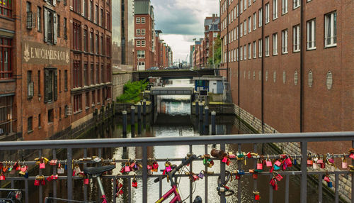 Bridge over canal amidst buildings in city