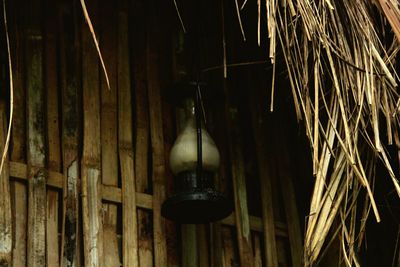 Low angle view of illuminated light bulb hanging on ceiling