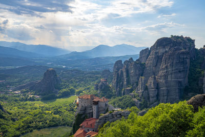 Scenic view of mountains against cloudy sky