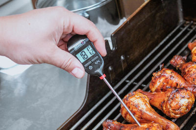 High angle view of man preparing food on barbecue grill