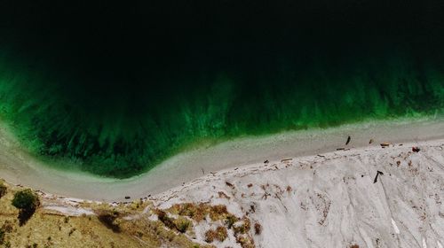 Panoramic view of land and sea against mountains