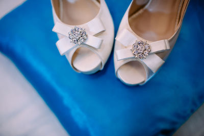 High angle view of white shoes on blue tablecloth