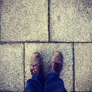 Low section of man standing on paved street