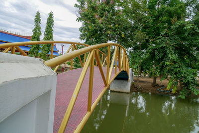 Bridge over swimming pool by lake