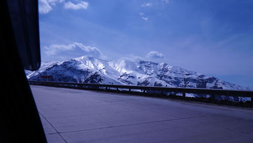 Scenic view of snowcapped mountains against blue sky