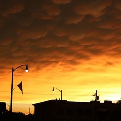 Silhouette landscape against cloudy sky