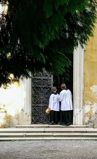 Rear view of man and woman walking on tree