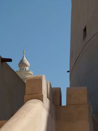 Low angle view of building against clear blue sky