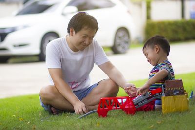 Cute boy sitting in park