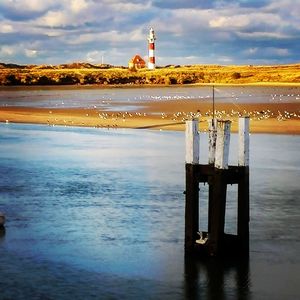 Lighthouse by sea against sky