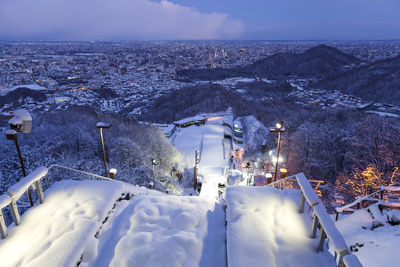 High angle view of snow covered buildings in city