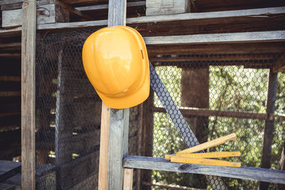 Close-up of yellow lamp hanging on metal railing