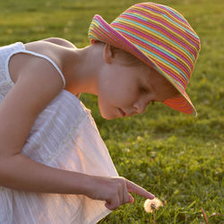 Close-up of cute baby girl on field