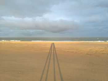 View of beach against cloudy sky