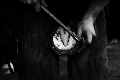 Close-up of human hand holding clock