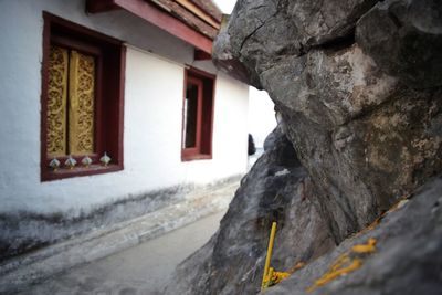 Close-up of snow on rock against building