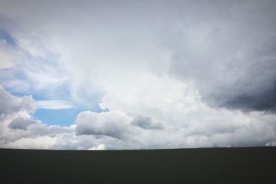 Scenic view of landscape against cloudy sky