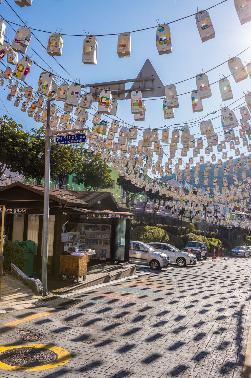 architecture, built structure, building exterior, nature, sky, building, tradition, city, decoration, day, town, outdoors, no people, street, sunlight, hanging, travel destinations, celebration, religion